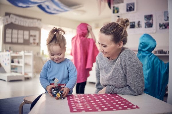 Barn och pedagog som leker.